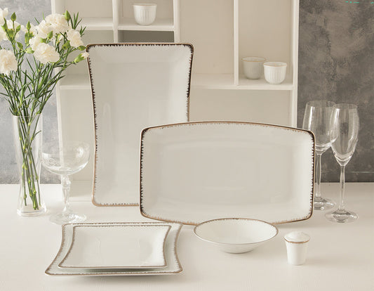 Royal-serviset i hvitt porselen med elegante platinadetaljer, vist med serveringsfat, skåler og tallerkener i en lys og stilren borddekking